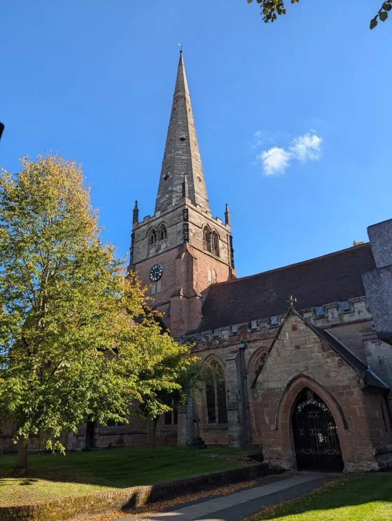 Historic church with a tall spire on a sunny day